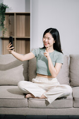 Happy lady working sitting on sofa at home office. successful entrepreneurship and career concept.