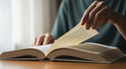 Person Turning Page of Open Book Reading Concept.