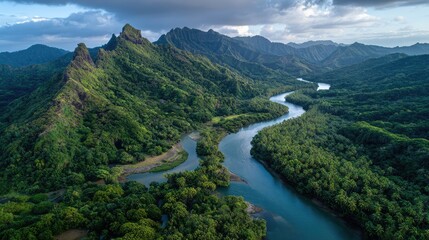Aerial View of Lush Green River Valley Surrounded by Majestic Mountains and Vivid Foliage Under a Dramatic Sky, Capturing the Natural Beauty of a Tropical Landscape