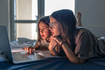 Girls with laptop. Kids online world. Focused look