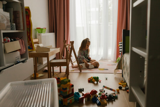Child playing with toys in sunny living room showing creativity and care