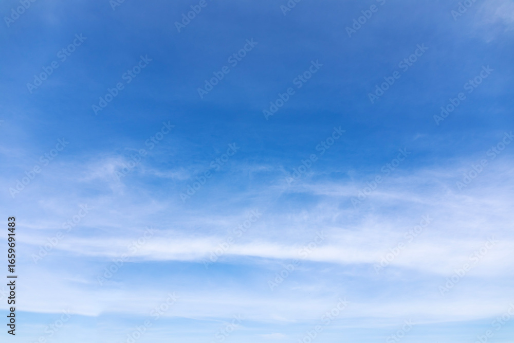Wall mural blue sky background and white clouds soft focus, and copy space horizontal shape.