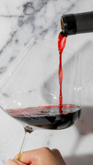 Rich garnet wine cascades into crystalline elegance, echoing Saint Vincent's Day and candlelit...