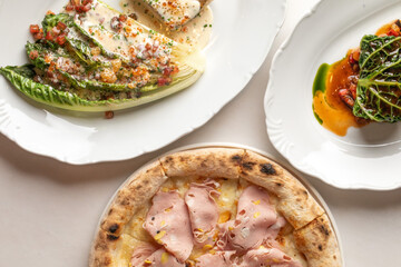 Savor the artisan fusion of rustic ham pizza and vibrant salad duo, perfect for World Food Day celebrations