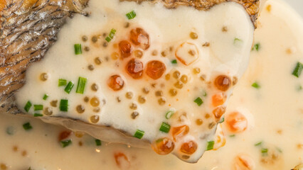 Luscious fish crowned with creamy sauce and vibrant roe, reminiscent of Baltic sea feasts, perfect for Maslenitsa celebrations