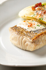 Golden-crisped fish rests with smoky paprika whispers, evoking coastal feasts and Solstice supper, a Nordic culinary serenade