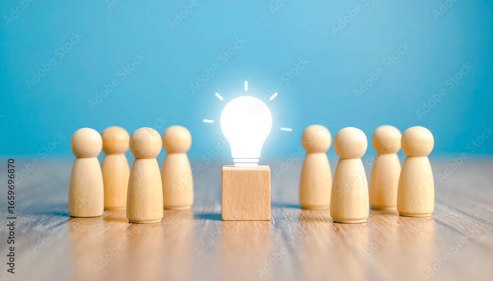 Aufkleber conceptual image of an illuminated lightbulb standing in front of a group of wooden figures represen