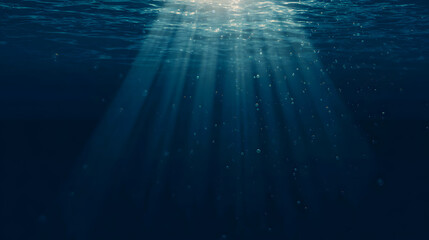 Sunlight streams through ocean waves, creating a mesmerizing play of light and shadow in deep blue waters.