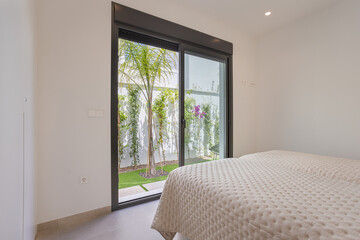 Fototapeta premium Bedroom with Garden Access Through Sliding Door