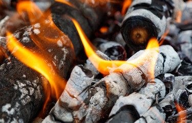 A pile of wood with a lot of ash and charred wood