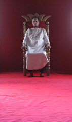 king in white robe on throne
