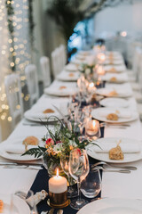 Romantic wedding dinner table with candlelight and floral centerpiece