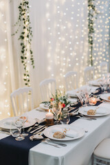 Romantic wedding dinner table with candlelight and floral centerpiece