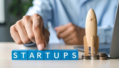 A concept image about startup with hand and rocket