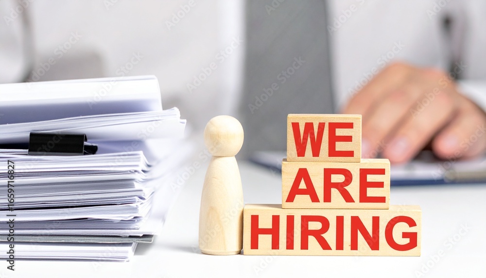 Aufkleber an image depicting a 'we are hiring' message with documents and a person-shaped figure on a desk. th