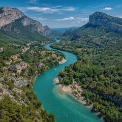 High Angle View Of Turquoise River Winding Through Mountain Canyon