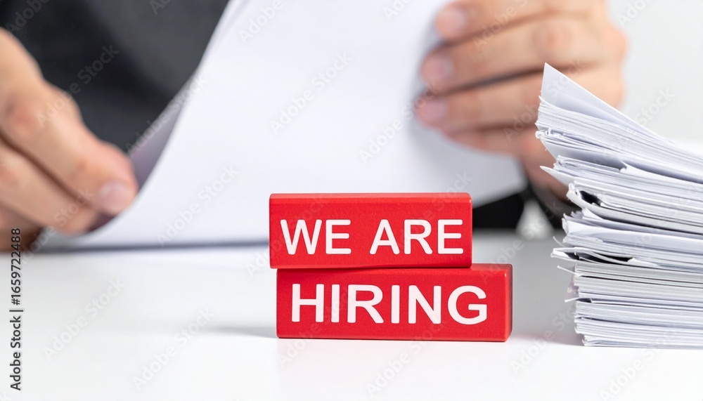 Poster hiring concept. a pair of hands sorting through document with hiring sign