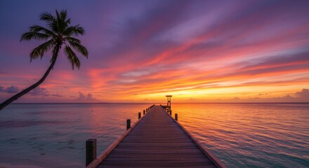 Obraz premium Vibrant Tropical Sunset Over Ocean With Palm Tree Silhouette and Wooden Pier