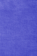 Fototapeta premium Close-up of blue corduroy trousers pants fabric background backdrop. Traditional fashion garment fabric concept.