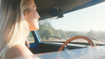 Naklejka premium Young Woman On Road Trip Driving In Cab Of Pick Up Truck