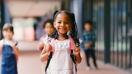 Portrait Of Smiling Female Elementary School Pupil Outdoors With Backpack At School