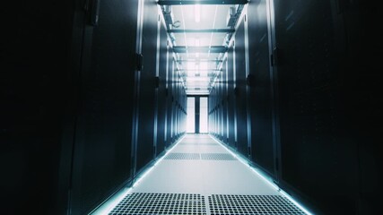 Camera Moves Through Data Center Aisle Lined With Black Server Racks, Showing Modern Infrastructure, Secure Cloud Computing, Artificial Intelligence, and Business Data Operations. - Powered by Adobe
