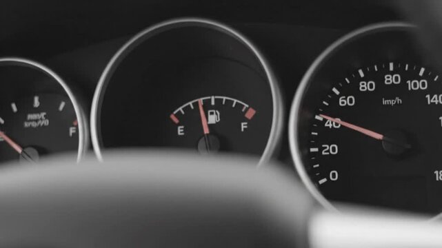 Car Dashboard Displaying Speedometer and Fuel Gauge in Monochrome Style