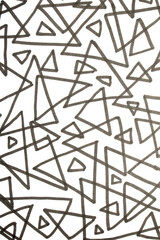 Close up of hand drawn doodle pen triangle square black lines and waves on white background