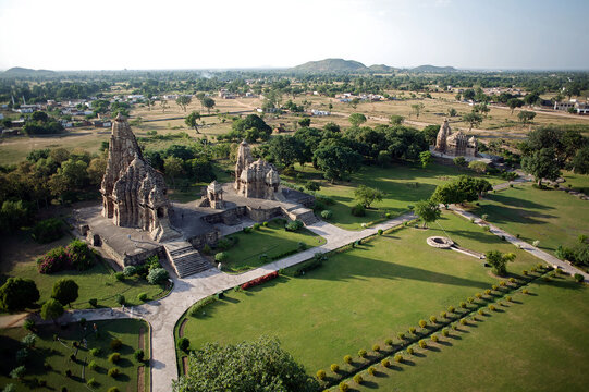 Aerial view of striking temples and lush green lawns meet in Khajuraho's historic landscape, a blend of ancient architecture and manicured nature, Khajuraho, Madhya Pradesh, India.