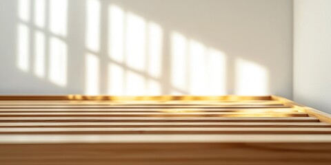 Sunlight streams through a window, casting long, vertical shadows across a wooden bed frame. The light creates a dramatic contrast between the bright illuminated area and the dark background.