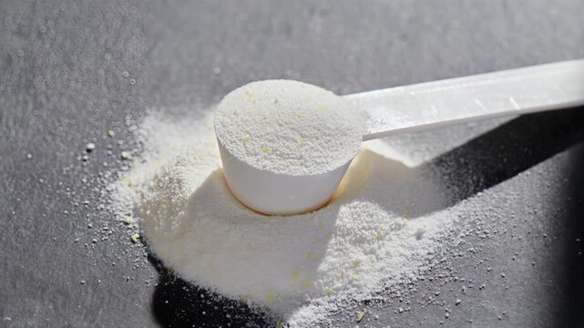 Sport supplement powder lifestyle. Supplement, creatine, hmb, bcaa, amino acid or vitamin in a white scoop. Sport nutrition concept. Food supplement.