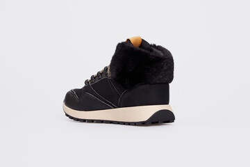 Women's fashion winter high-top sneaker with laces isolated on white background. Sports leather boot for female with fur. Shoe with thick sole. Luxury footwear mock up, template. Back rear view