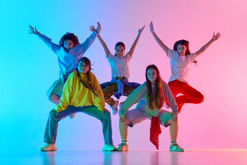 A dynamic group of diverse young adults showcases youthful urban dance culture in a vibrant, colorful performance. Concept of modern city arts and youth expression.