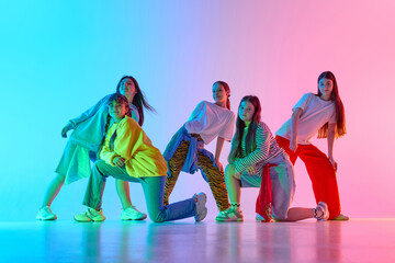 Youthful dancers express energy in a vibrant urban dance performance against a colorful backdrop. Concept of dynamic motion and modern art in urban settings.