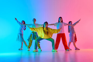 Vibrant dancers embody youthful energy and teamwork in a colorful urban dance performance. Concept of artistic expression and teamwork in diverse cultural settings.