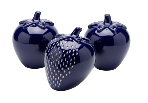 Three abstract indigo ceramic strawberry forms, one with silver seeds, two solid, isolated on a transparent background with copy space and soft reflections. Modern minimalist design concept - Powered by Adobe