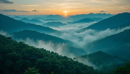 Beautiful sunrise over green mountains with misty clouds