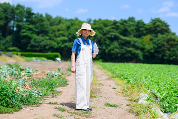 高原で水分補給する女の子　アウトドア・健康イメージ