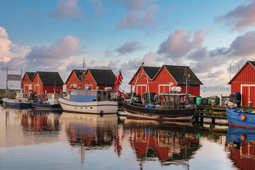 Fototapeta premium Idyllic red fishermen's huts with reflections in the fishing port of Tarnewitz-Boltenhagen