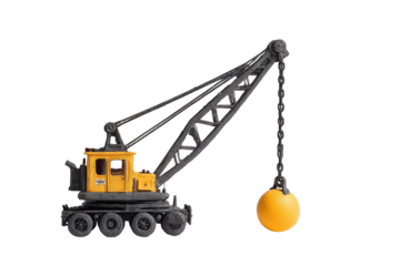 Yellow and gray crane lifting a large yellow ball
