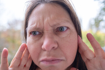 caucasian mature woman holding painful ear close up, hearing loss, Ear Discomfort, Hearing Test,...