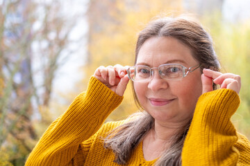 Mature woman 50 years old wearing glasses, poor vision, myopia problem, optical exam, diopter...