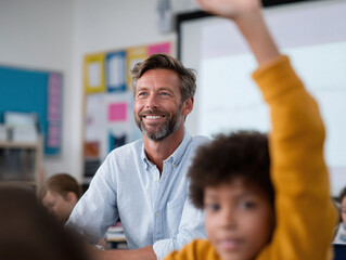Smiling teacher in a classroom setting with a student raising their hand. Represents education, learning, and positive interactions. Ideal for educational materials, websites, and advertising.