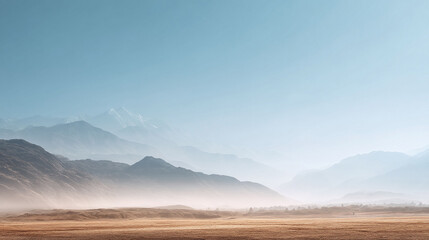 Serene mountain landscape with rolling hills shrouded in mist. The soft, desaturated color palette creates a peaceful and ethereal mood. Ideal for travel or nature themes.