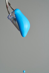 Cyan paint drop falling from led