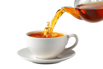 Hot tea being poured into a white teacup