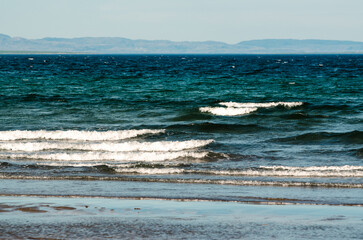 surf waves of clear blue waters of the Arctic Ocean