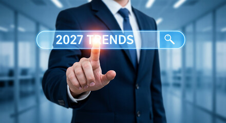 Businessman touching digital search bar with text 2027 trends symbolizing future business and technology innovation