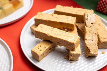 Close-up of a plate with soft nougat or Jijona turron, served on a Christmas table. A traditional Spanish sweet