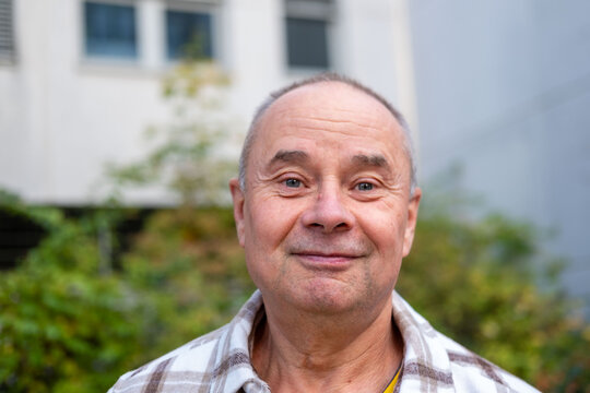 happy positive caucasian mature senior man 60-65 years old smiling on natural background, good mood, age-related changes, mental human health, enjoying nature, golden years